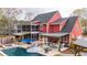 Backyard featuring a pool, hot tub, screened-in porch, and outdoor kitchen, ideal for outdoor living at 1149 Lands End Dr, Hanahan, SC 29410