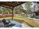 A lush backyard with a sparkling pool, a covered patio, and manicured greenery providing a tranquil retreat at 1149 Lands End Dr, Hanahan, SC 29410