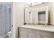 Well-lit bathroom featuring double sinks, marble countertop, and a large mirror at 1149 Lands End Dr, Hanahan, SC 29410