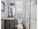 This bathroom features a glass shower enclosure and a charming vanity with mirror and light fixtures at 1149 Lands End Dr, Hanahan, SC 29410