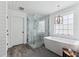 Freestanding bathtub and walk-in shower with marble accents at 1149 Lands End Dr, Hanahan, SC 29410