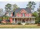 Inviting two-story home with a charming, expansive front porch and well-maintained landscaping at 1149 Lands End Dr, Hanahan, SC 29410