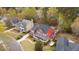 Aerial view of a red two-story home featuring a covered front porch, landscaped yard and views of the surrounding community at 1149 Lands End Dr, Hanahan, SC 29410