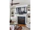 Elegant fireplace with built-in shelving, a large TV, and stylish decor in the living room at 1149 Lands End Dr, Hanahan, SC 29410
