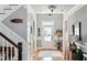Elegant foyer featuring hardwood floors, decorative lighting, and staircase leading to the upper level at 1149 Lands End Dr, Hanahan, SC 29410