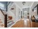 Elegant foyer showcasing a staircase, hardwood floors, and stylish decor leading to a front door at 1149 Lands End Dr, Hanahan, SC 29410
