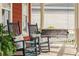 Inviting front porch area showcasing rocking chairs and a cozy porch swing with decorative pillows at 1149 Lands End Dr, Hanahan, SC 29410