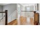 Hallway with hardwood floors, white wainscoting, and a glimpse into a bedroom at 1149 Lands End Dr, Hanahan, SC 29410