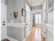 An interior hallway features hardwood floors, white trim and grey paint at 1149 Lands End Dr, Hanahan, SC 29410
