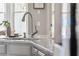 Close-up of a stainless steel faucet paired with a white marble countertop and grey cabinets at 1149 Lands End Dr, Hanahan, SC 29410