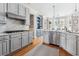 Charming kitchen with grey cabinets, marble countertops, stainless appliances, and hardwood flooring at 1149 Lands End Dr, Hanahan, SC 29410