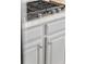 A close-up showcases the sleek stainless steel gas cooktop with marble countertops and hardware at 1149 Lands End Dr, Hanahan, SC 29410