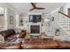 Cozy living room with comfortable seating, built-in shelving, fireplace, and staircase in view at 1149 Lands End Dr, Hanahan, SC 29410