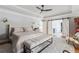 Bright main bedroom featuring a tray ceiling, ceiling fan, barn doors, and ensuite bathroom at 1149 Lands End Dr, Hanahan, SC 29410