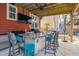 Outdoor kitchen featuring a granite counter top, bar seating, TV, and ceiling fan for entertainment at 1149 Lands End Dr, Hanahan, SC 29410