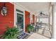 Inviting front porch with rocking chairs, swing and decorative plants at 1149 Lands End Dr, Hanahan, SC 29410
