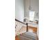 Staircase landing with a cushioned bench seat, decorated with pillows, under a sunny window at 1149 Lands End Dr, Hanahan, SC 29410