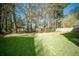 Expansive backyard with lush grass, mature trees, and a privacy fence at 115 Trickle Dr, Summerville, SC 29483