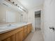 Bathroom featuring a double sink vanity, a large mirror, and a shower-tub combo in the background at 115 Trickle Dr, Summerville, SC 29483