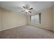 A bright bedroom with carpet flooring, a ceiling fan, and a window with gray curtains at 115 Trickle Dr, Summerville, SC 29483