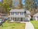 Charming two-story home with blue shutters, a welcoming front porch, and well-maintained landscaping at 115 Trickle Dr, Summerville, SC 29483