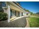 Covered porch with white columns and blue shutters, complemented by a neat mulch bed and green lawn at 115 Trickle Dr, Summerville, SC 29483