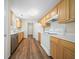 A well-lit kitchen features wood flooring, wooden cabinets, and modern appliances including a stainless steel dishwasher at 115 Trickle Dr, Summerville, SC 29483