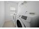 This functional laundry room has modern appliances and a bright window at 115 Trickle Dr, Summerville, SC 29483