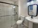 Modern bathroom with a sleek shower, black framed mirror, and pedestal sink at 117 Coronet St, Summerville, SC 29483