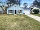 Charming light blue single-story home with black shutters and a well-maintained front lawn at 117 Coronet St, Summerville, SC 29483