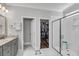 Bathroom featuring double sinks, granite countertop, a walk-in closet, and a separate shower at 1173 Triple Crown Court, Mount Pleasant, SC 29429