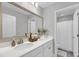 Modern bathroom with double sinks, white cabinets, and a framed mirror with decor at 1173 Triple Crown Court, Mount Pleasant, SC 29429