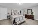 Comfortable bedroom featuring carpet floors, a dresser, and bench seating with modern decor at 1173 Triple Crown Court, Mount Pleasant, SC 29429
