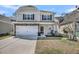 Charming two-story home with stone accents, a two-car garage, and a well-manicured front yard at 1173 Triple Crown Court, Mount Pleasant, SC 29429