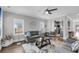 Open-concept living room featuring a ceiling fan, a comfortable sofa, and a view of the kitchen at 1173 Triple Crown Court, Mount Pleasant, SC 29429