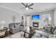 Cozy living room with fireplace, ceiling fan, and access to an outdoor area through glass doors at 1173 Triple Crown Court, Mount Pleasant, SC 29429