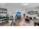 Open living space featuring luxury vinyl plank, natural light, and an exercise bike at 1173 Triple Crown Court, Mount Pleasant, SC 29429