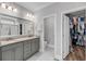 Main bathroom featuring double sinks, granite countertop, a walk-in closet, and a separate water closet at 1173 Triple Crown Court, Mount Pleasant, SC 29429