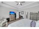 Spacious main bedroom with dresser, TV, access to the bath, and a relaxing chair near the windows at 1173 Triple Crown Court, Mount Pleasant, SC 29429