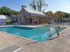 Community pool and poolside building with shaded lounge area, seating, and a serene setting at 1173 Triple Crown Court, Mount Pleasant, SC 29429