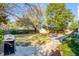 Spacious backyard featuring a patio dining set, storage shed, and mature trees providing shade at 1200 Island View Dr, Mount Pleasant, SC 29464