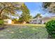Well-kept backyard with lush lawn, mature trees, a storage shed, and a patio dining set near the house at 1200 Island View Dr, Mount Pleasant, SC 29464