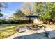 Lush backyard with a dining set under an umbrella, mature trees, and a well-maintained lawn at 1200 Island View Dr, Mount Pleasant, SC 29464