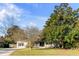 Inviting home with a front porch and rocking chairs, complemented by mature trees and a well-kept lawn at 1200 Island View Dr, Mount Pleasant, SC 29464