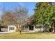 Charming home with inviting front porch, rocking chairs, mature trees, and well-manicured lawn at 1200 Island View Dr, Mount Pleasant, SC 29464