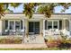 Charming brick home featuring a welcoming front porch with seating and a meticulously landscaped entrance at 1200 Island View Dr, Mount Pleasant, SC 29464