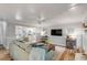 Open-concept living room with a glimpse of the kitchen, featuring comfortable seating and modern appliances at 1200 Island View Dr, Mount Pleasant, SC 29464