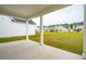 Covered patio opens to spacious green backyard with views of neighborhood homes at 123 Moscato Ln, Summerville, SC 29485