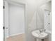 Powder room featuring a pedestal sink, large mirror, and light wood flooring at 123 Moscato Ln, Summerville, SC 29485