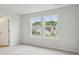 Neutral bedroom with double window overlooking neighboring houses and landscaped backyards at 123 Moscato Ln, Summerville, SC 29485